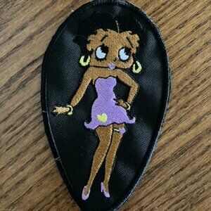 Black Betty Boop embroidered patch donning usual skimpy lavender dress and shoes